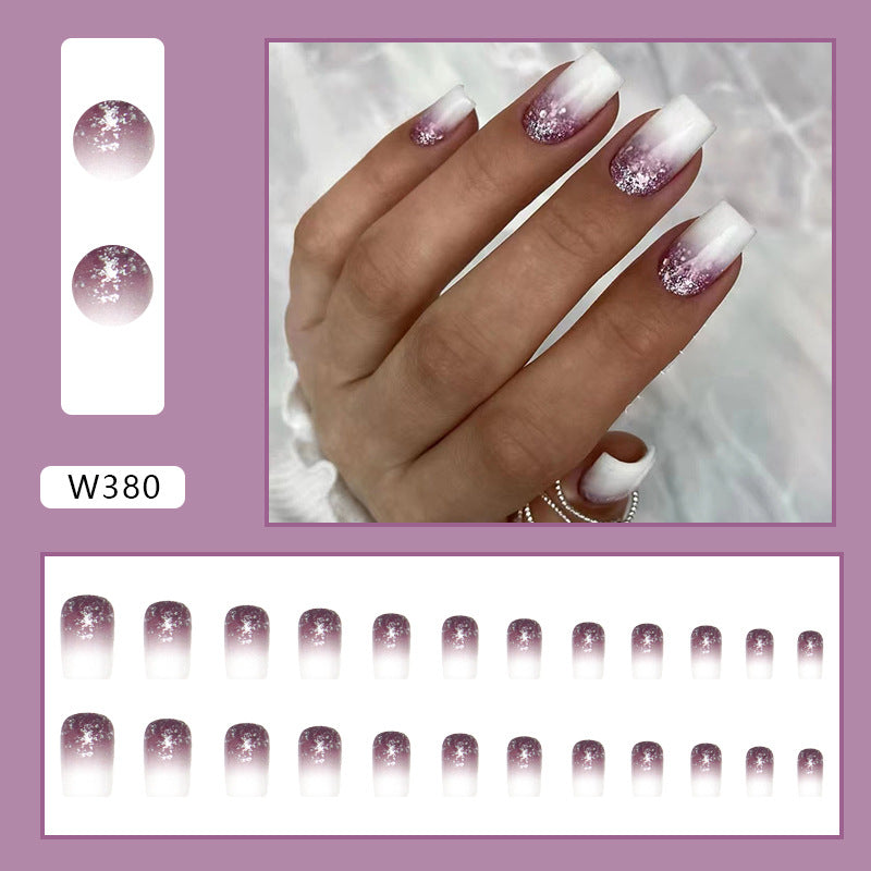 Full cover press-on almond nails in a purple glass finish, glossy finish shown on a hand