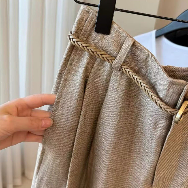 Waistband close-up showing front pleats side pocket and braided cord belt