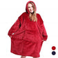 Woman in a red hooded wearable blanket with a front pocket, with red and navy color dots beside her
