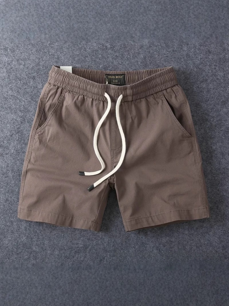 Khaki men's cotton drawstring shorts with the two open slant side pockets visible