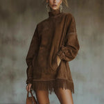 Brown oversized mock neck vegan suede fringe dress worn with tall boots front view