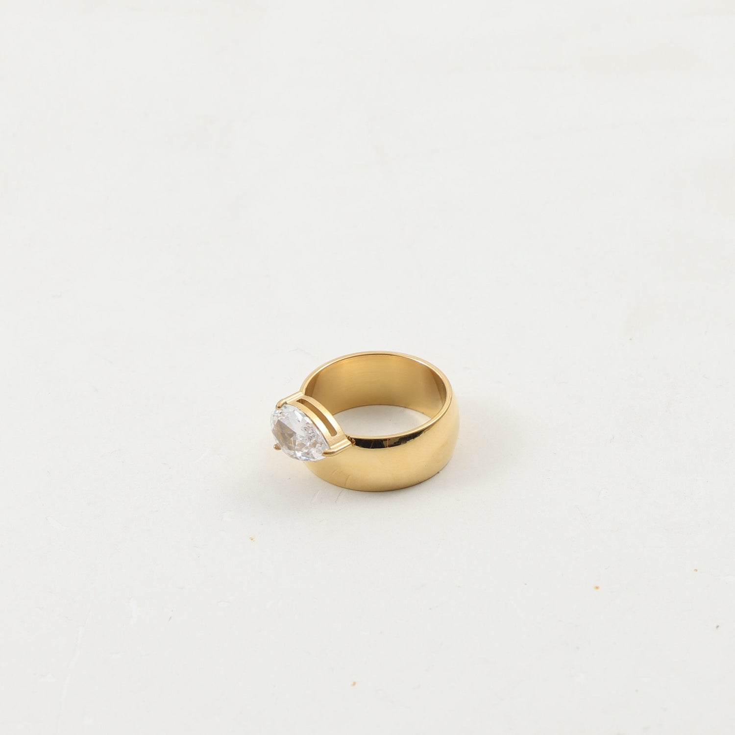 Gold-plated zircon ring worn on a hand, slim band sitting close to the finger
