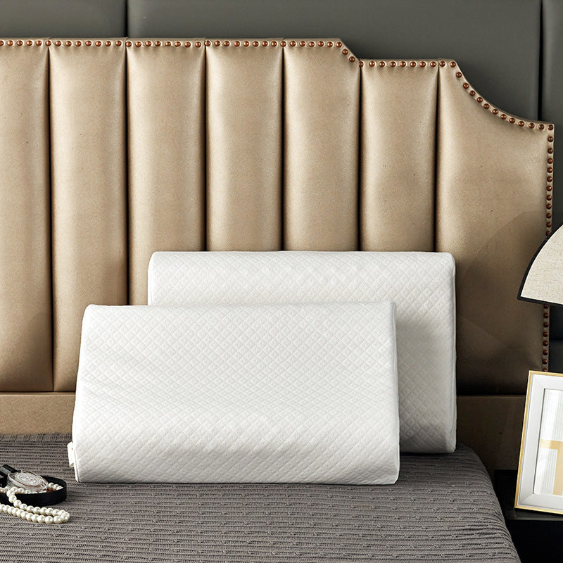 Cream latex contour pillow with a nub and ribbed surface and its white cover partly removed