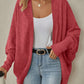 Light gray womens knit cardigan shown open with the sleeves pushed up