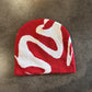 Red knit beanie with a contrast ghost fang pattern and high brimless crown