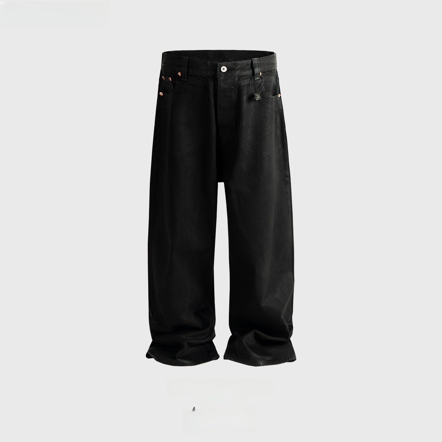 Studio flat lay of glossy black coated wide leg jeans with copper toned rivets and full belt loops