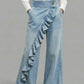 Light blue wide leg denim trousers with a cascading diagonal ruffle down the front leg
