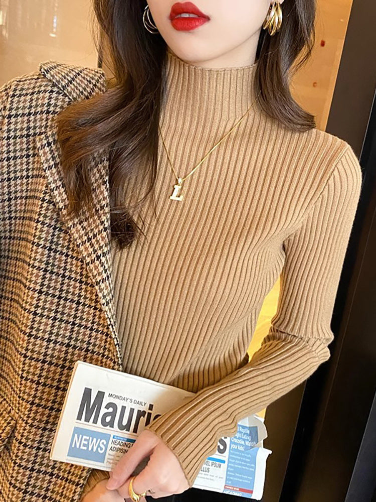 Fitted ribbed mock neck sweater in a quiet macaron tone shown close up on a model