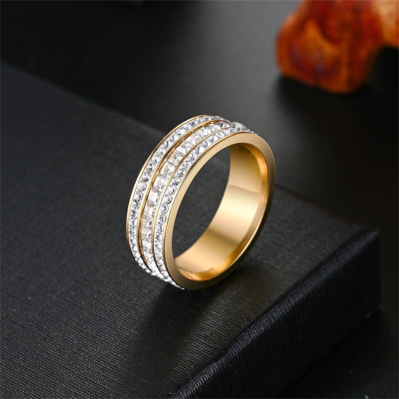 Gold tone three row cubic zirconia band ring on a black surface, size No. 12 option
