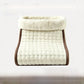 Off white quilted electric foot warmer with a cream plush cuff and brown trim, EU plug option