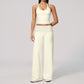 Model in a cropped camisole and wide leg fold over waist pants set, ivory with black polka dots