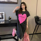 Loose pink heart print washed T-shirt dress with frayed hem, short sleeves on model