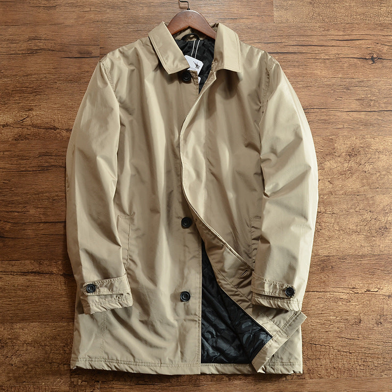 Khaki quilted lined coat with lapel collar on a hanger against a wood floor, size L option