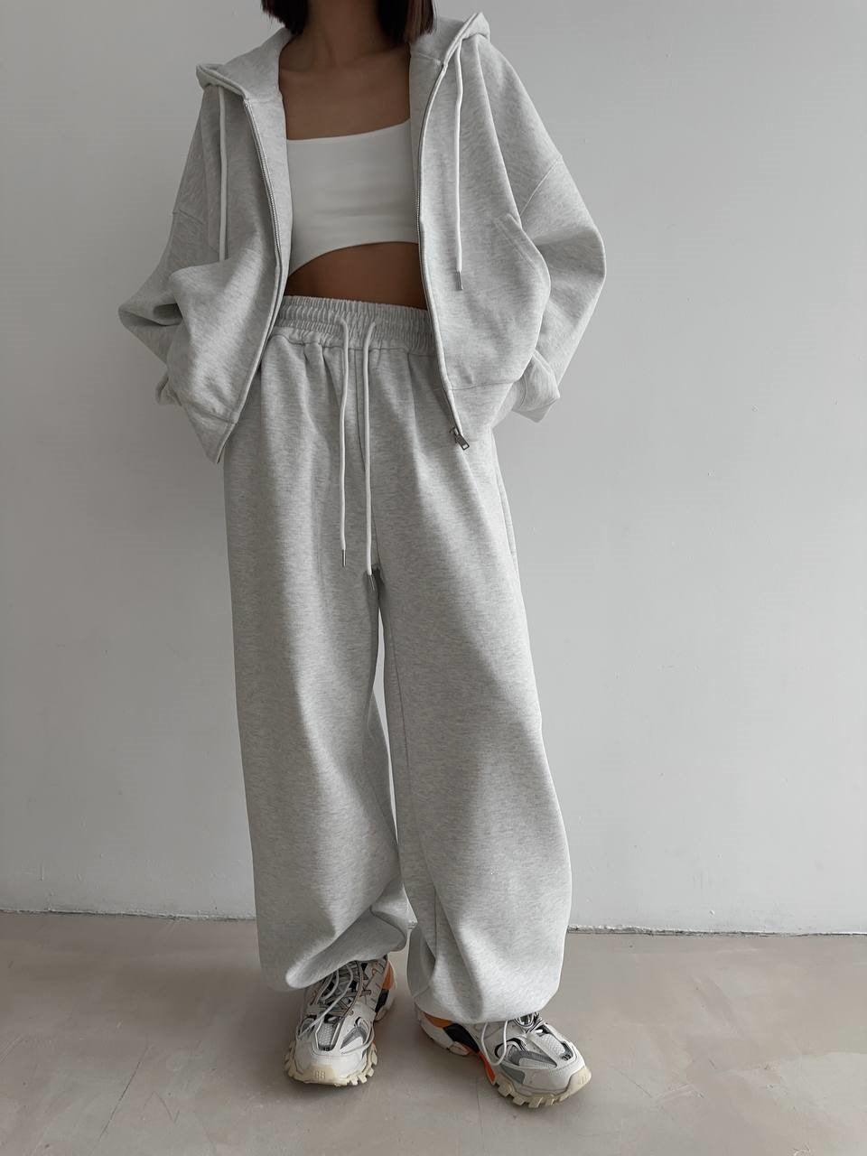 Light Gray zip-up hoodie and wide leg trousers set worn by a woman, option photo for size M