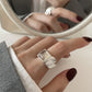 Detail of the silver ring finish and the stone-set geometric front