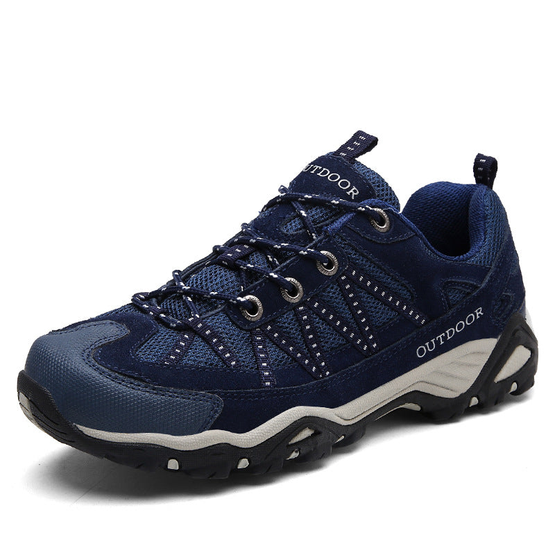 Toe cap and mesh vamp detail of a lace-up outdoor hiking shoe in an earth tone