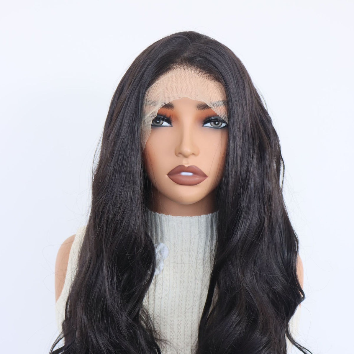 Close front view of a black wavy 13x4 lace front wig with a natural hairline and parting on a mannequin