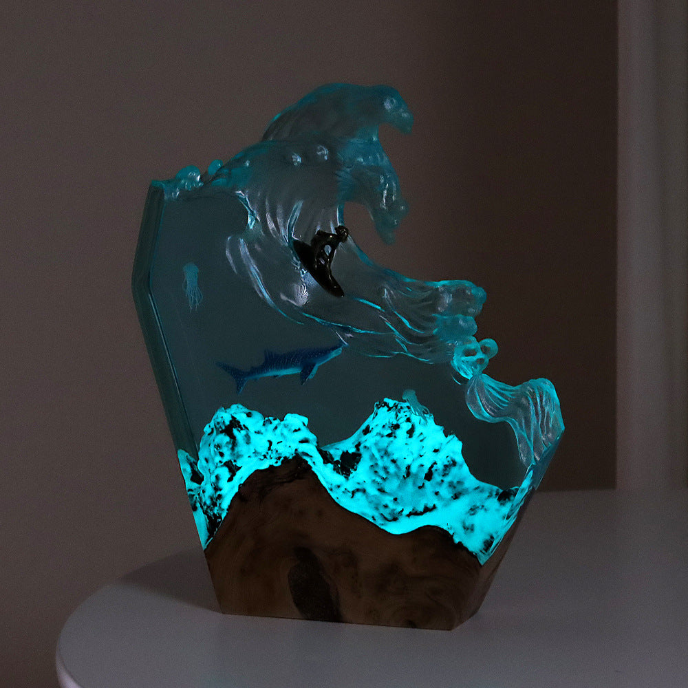 Ocean wave resin lamp glowing turquoise in the dark with lit reef base