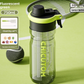 Fluorescent green 750 ml sports water bottle with black lid and internal straw on a green court