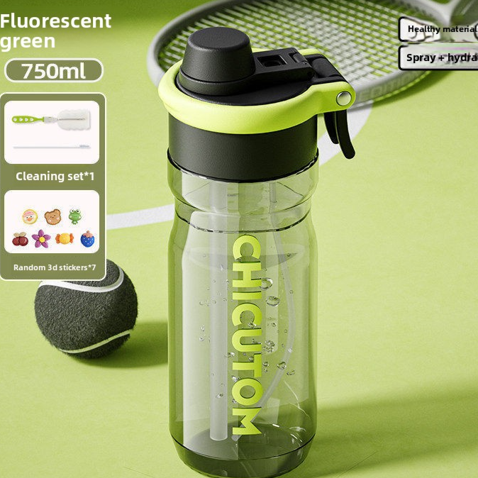 Fluorescent green 750 ml sports water bottle with black lid and internal straw on a green court