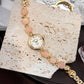 Womens vintage quartz watch on a stone beaded gold tone bracelet, studio shot