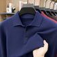 Navy blue knit polo collar and placket close up with fabric pulled in hand
