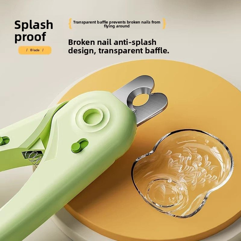 Green pet nail clipper with the clear catch baffle behind the stainless blade holding trimmed nail pieces