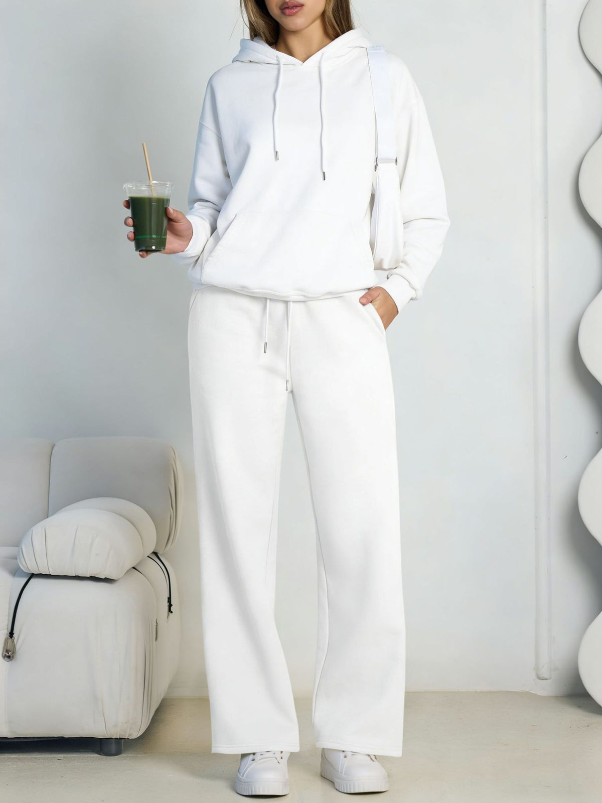 White fleece hooded sweatshirt and wide-leg sweatpants set worn by a model