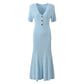 Elegant V-neck knitted dress shown from an angle to show the drape