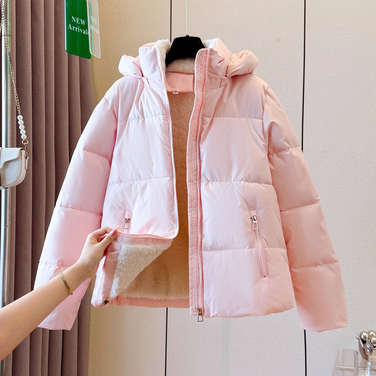Padded winter puffer jacket with a fleece lined hood and two zippered front pockets