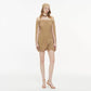 Macro detail of the soft ruched mesh fabric on the khaki mini dress