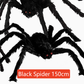 Hairy black Halloween spider prop with red eyes, flocked body and eight posable bendable legs
