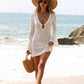 Long bell sleeve detail of an open knit beach cover-up dress worn over a swimsuit
