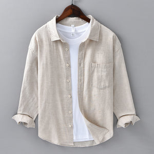 Mens cotton and linen blend long sleeve shirt in raw hemp beige on a wooden hanger, front view