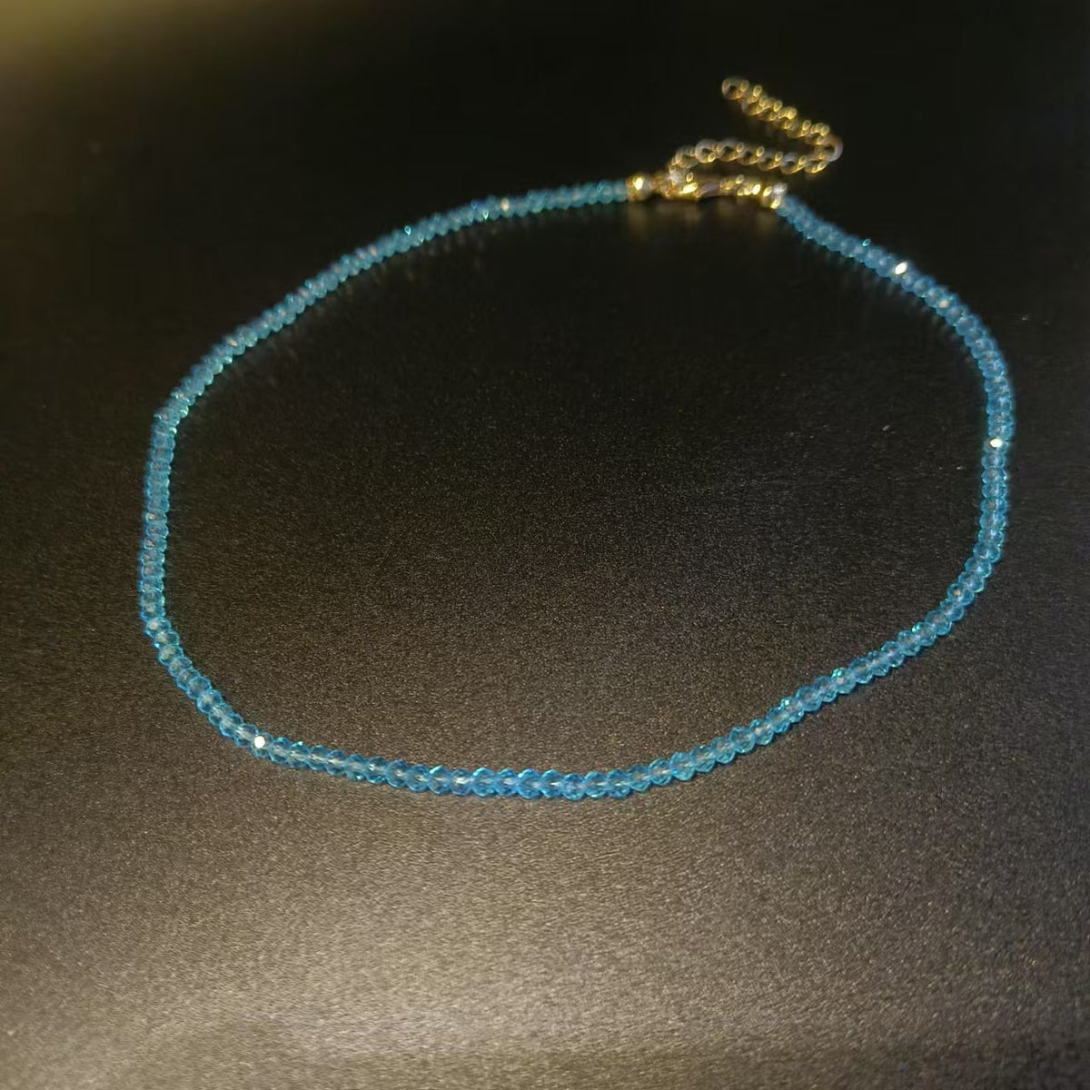 Detail of the faceted cut on the glass beads of the strand necklace