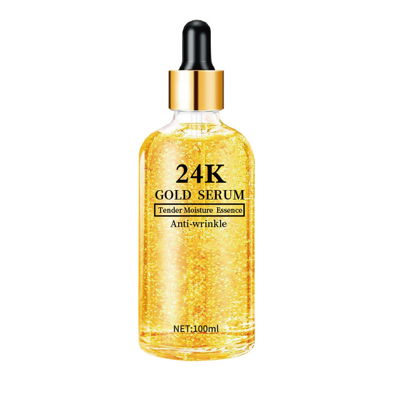 Golden 24K gold hyaluronic acid face serum in a glass dropper bottle with visible gold flecks