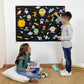 Two children playing with a space and solar system hanging felt story board on the wall