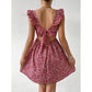 Floral square neck ruffle strap mini dress with a shirred bodice on a standing model, garden setting