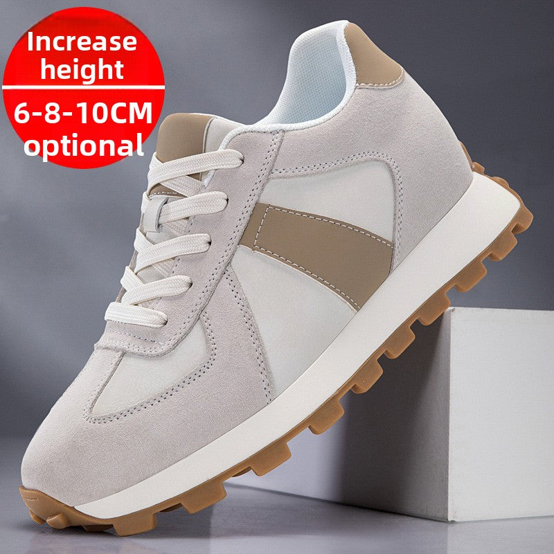 Light gray suede low top lace up sneaker with a taupe side stripe and a gum lug sole on a white block