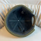 Khaki dome beanie with a ribbed knit cuff held in a hand