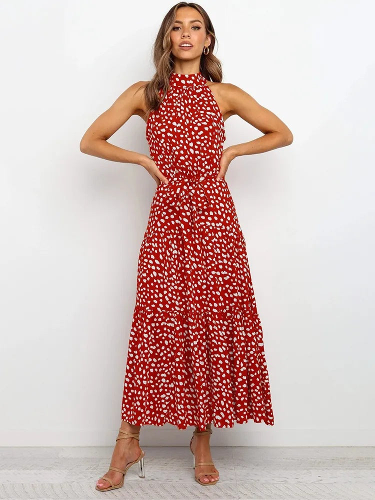Red polka dot halter neck sleeveless tiered swing maxi dress worn by a model