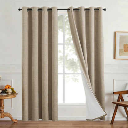Linen look polyester blackout grommet curtain panel with white thermal backing hanging by a bright living room window