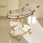 Gold serving cart lower glass shelf with bar tools shown from the side