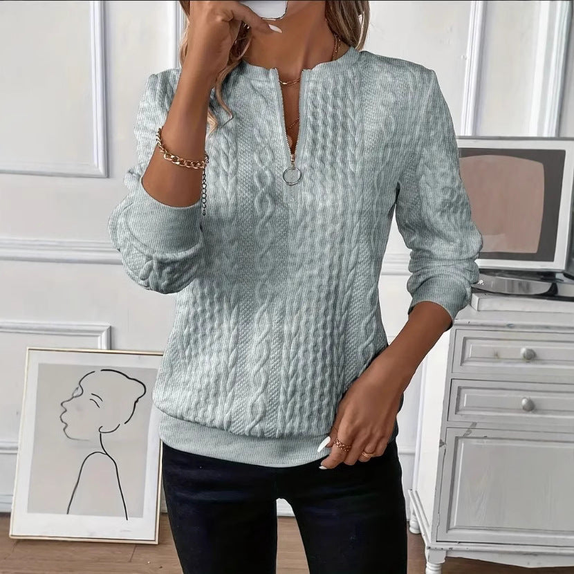 Close view of the raised cable knit texture on a polyester quarter zip pullover