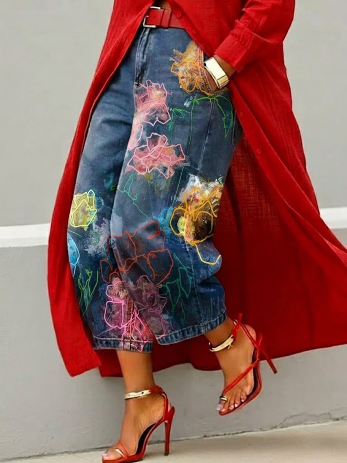 Wide leg cropped denim jeans with neon outline floral print in pink, orange and yellow, red coat and heels