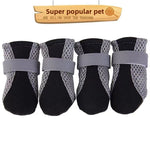 Set of four mesh dog shoes with black padded toe and grey reflective strap across the top