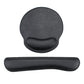Black memory foam wrist rest mouse pad with stitched edges on a desk