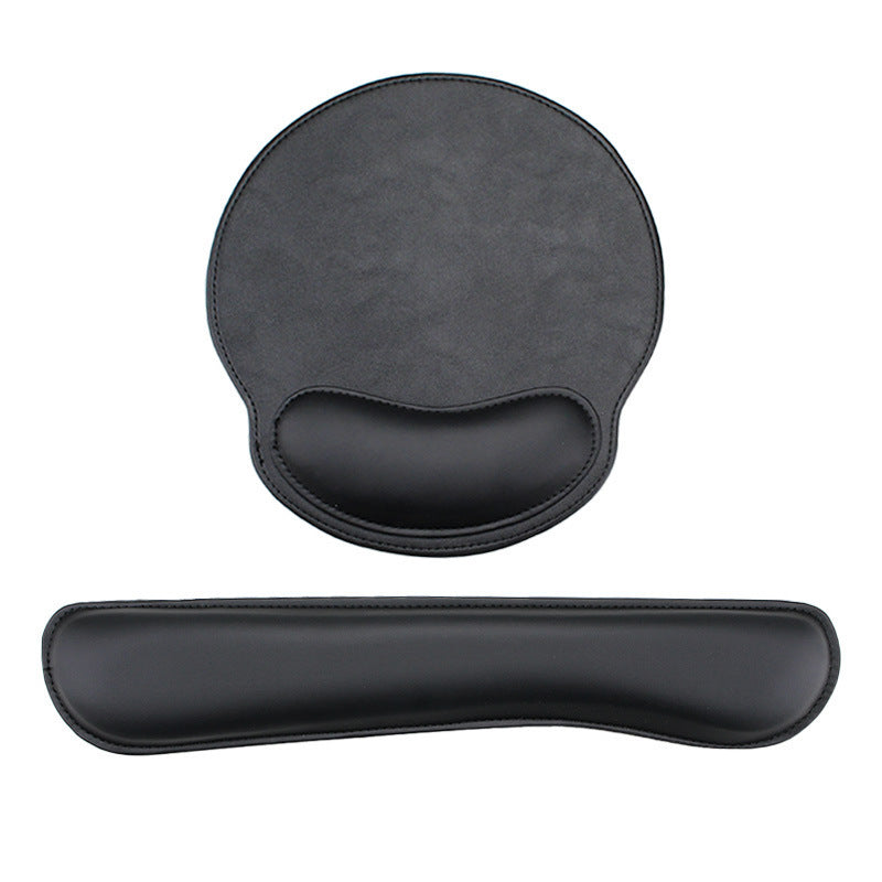 Black memory foam wrist rest mouse pad with stitched edges on a desk