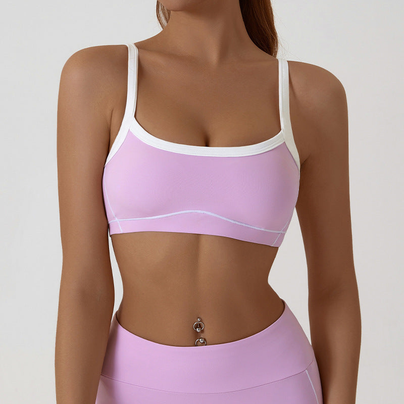 Back view of the sports bra with thin spaghetti straps crossing low across the shoulders