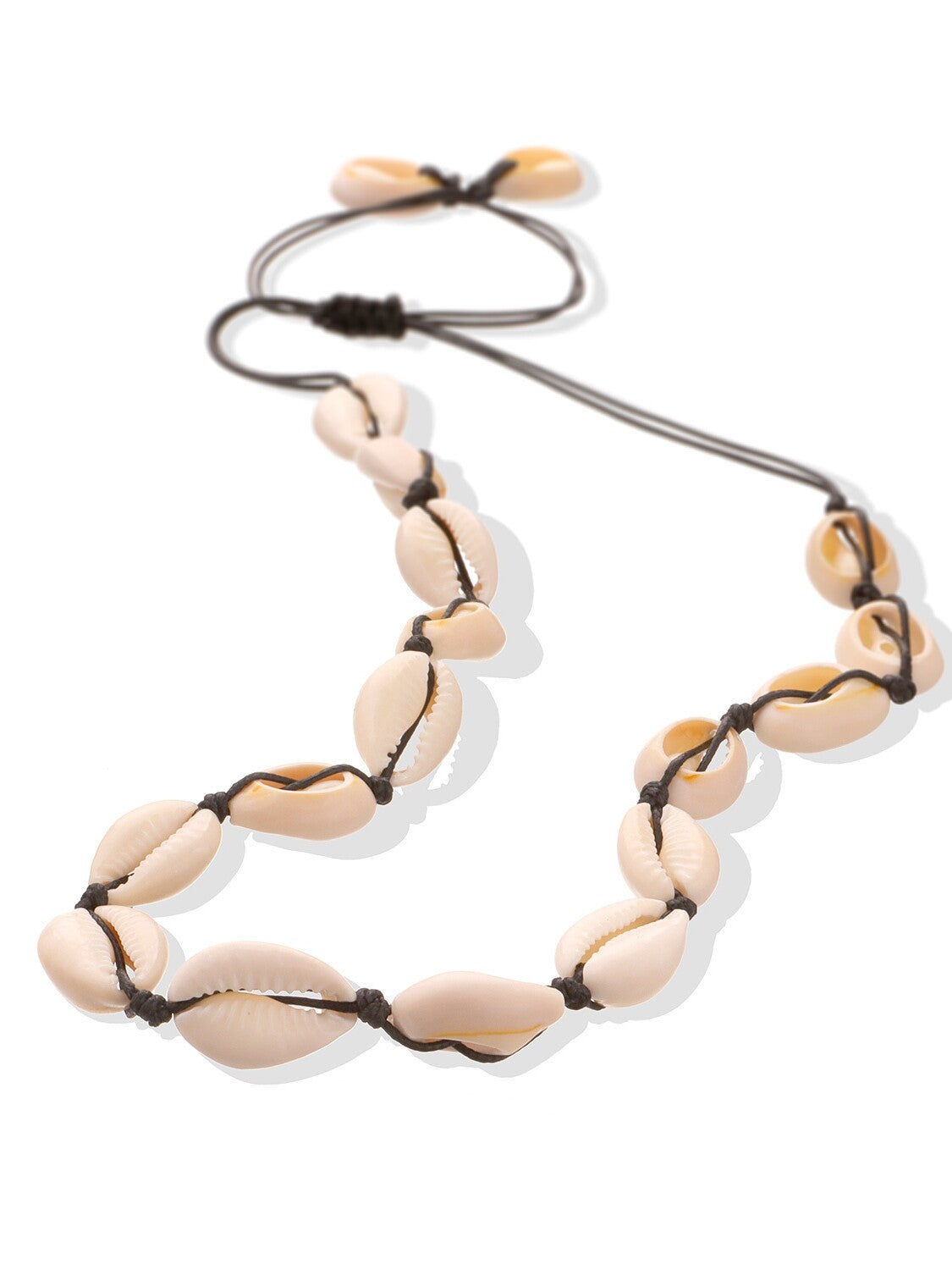 Cowrie shell choker on dark cord photographed at an angle, each shell knotted between two hitches